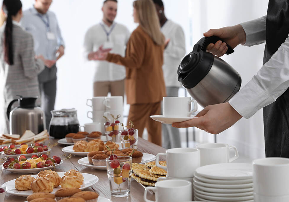 Waitress pouring hot drink during coffee break, closeup